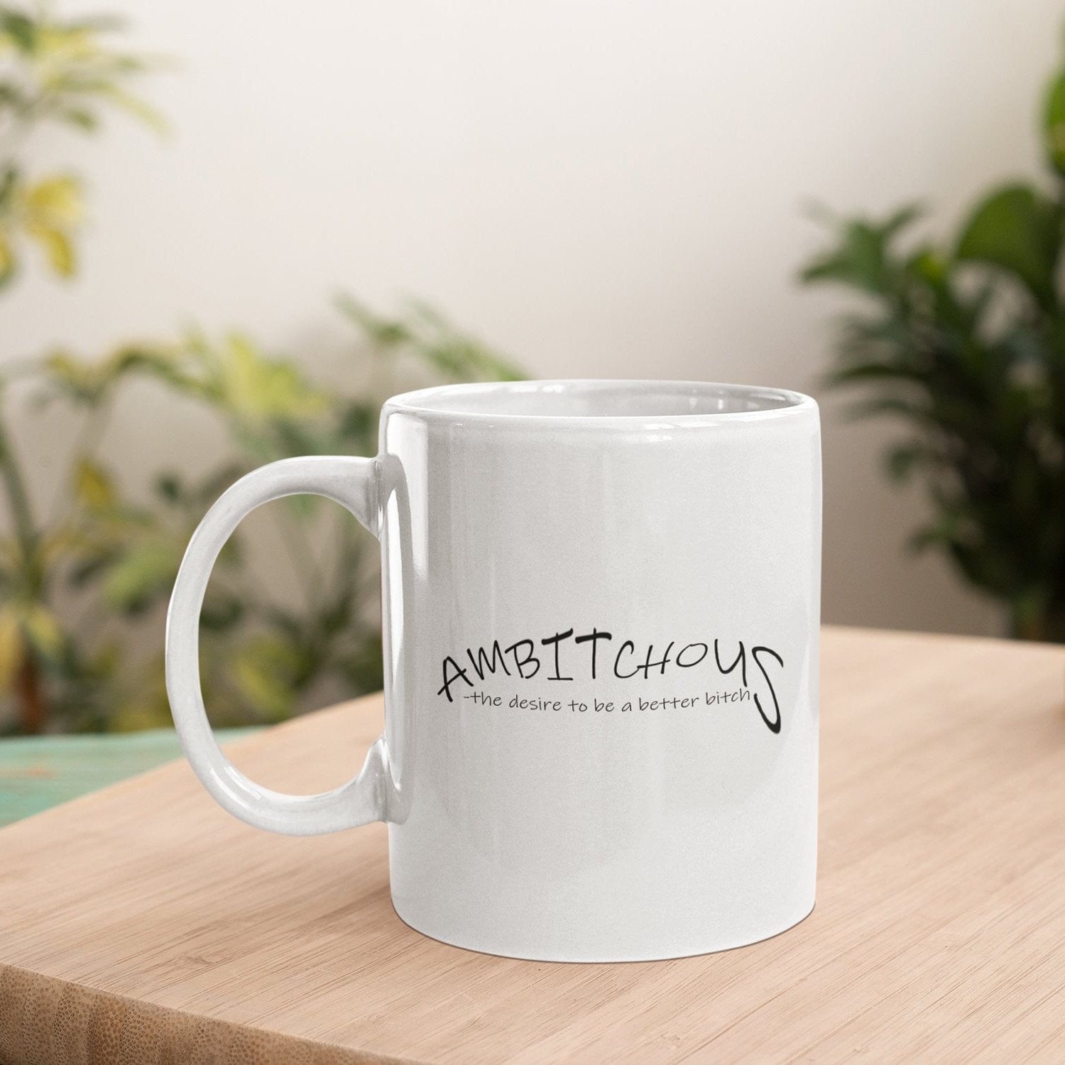 a white coffee mug sitting on top of a wooden table
