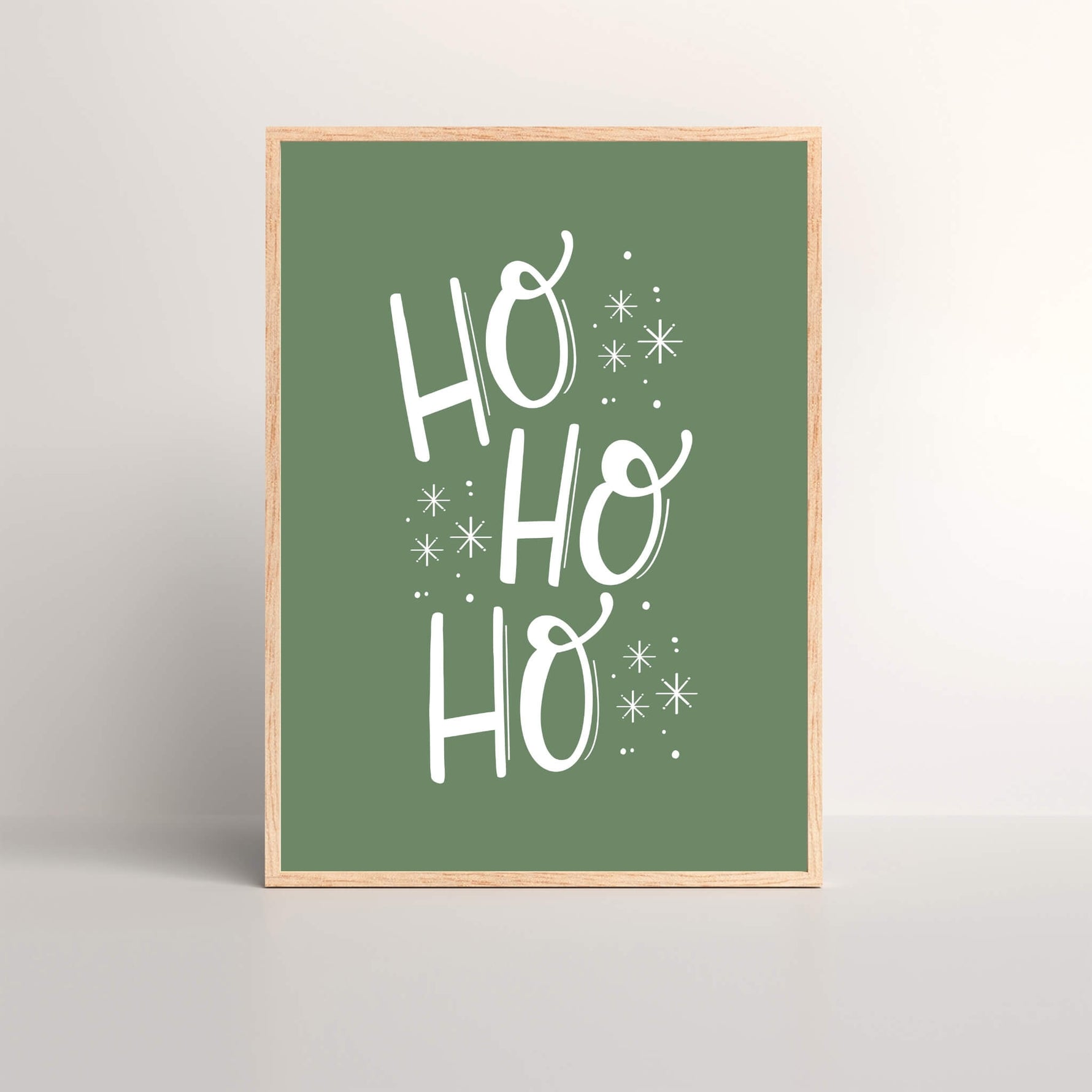 Framed Christmas art print of the saying HO-HO-HO with a green background and white font