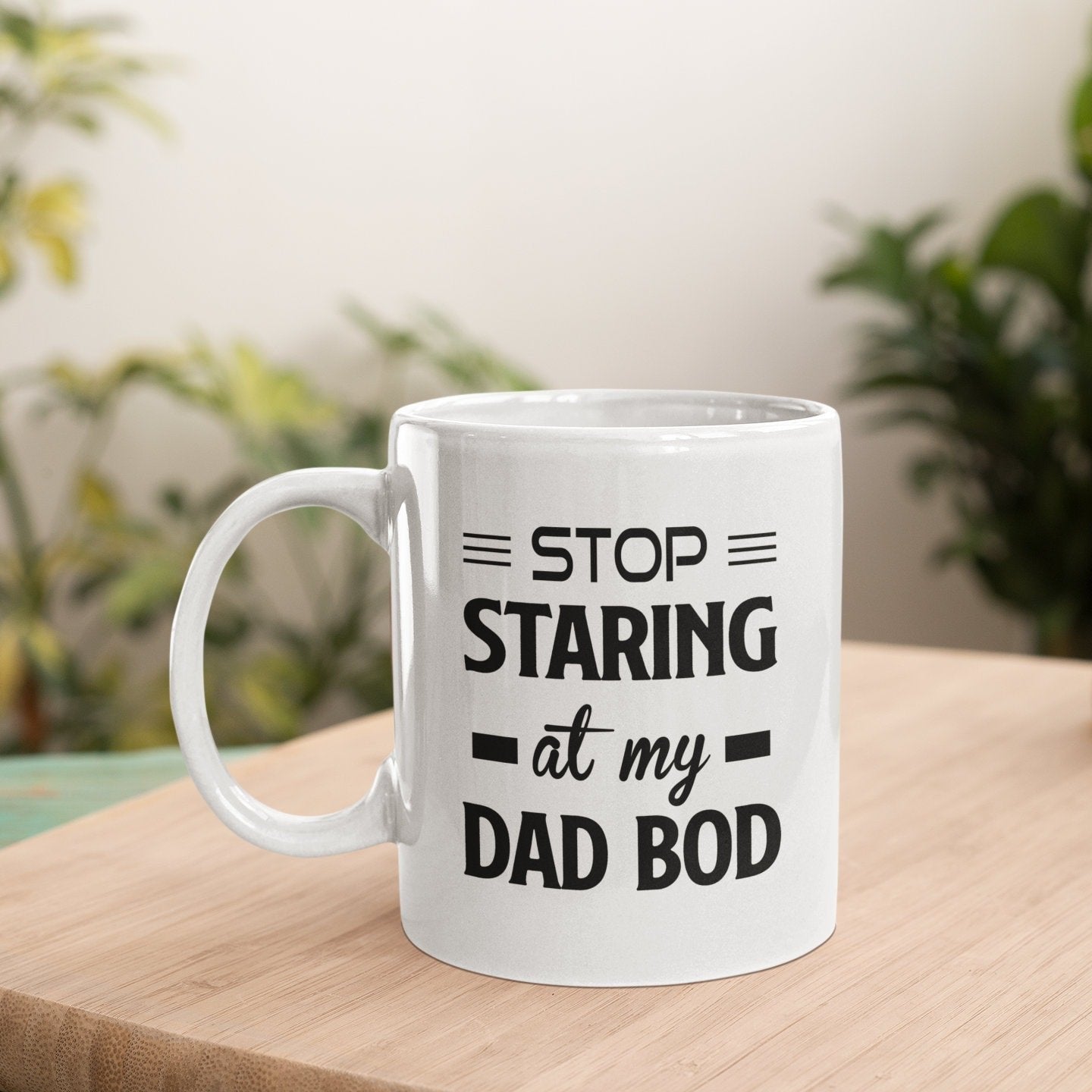 a white coffee mug sitting on top of a wooden table
