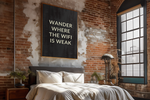 a bedroom with a brick wall and wooden floors