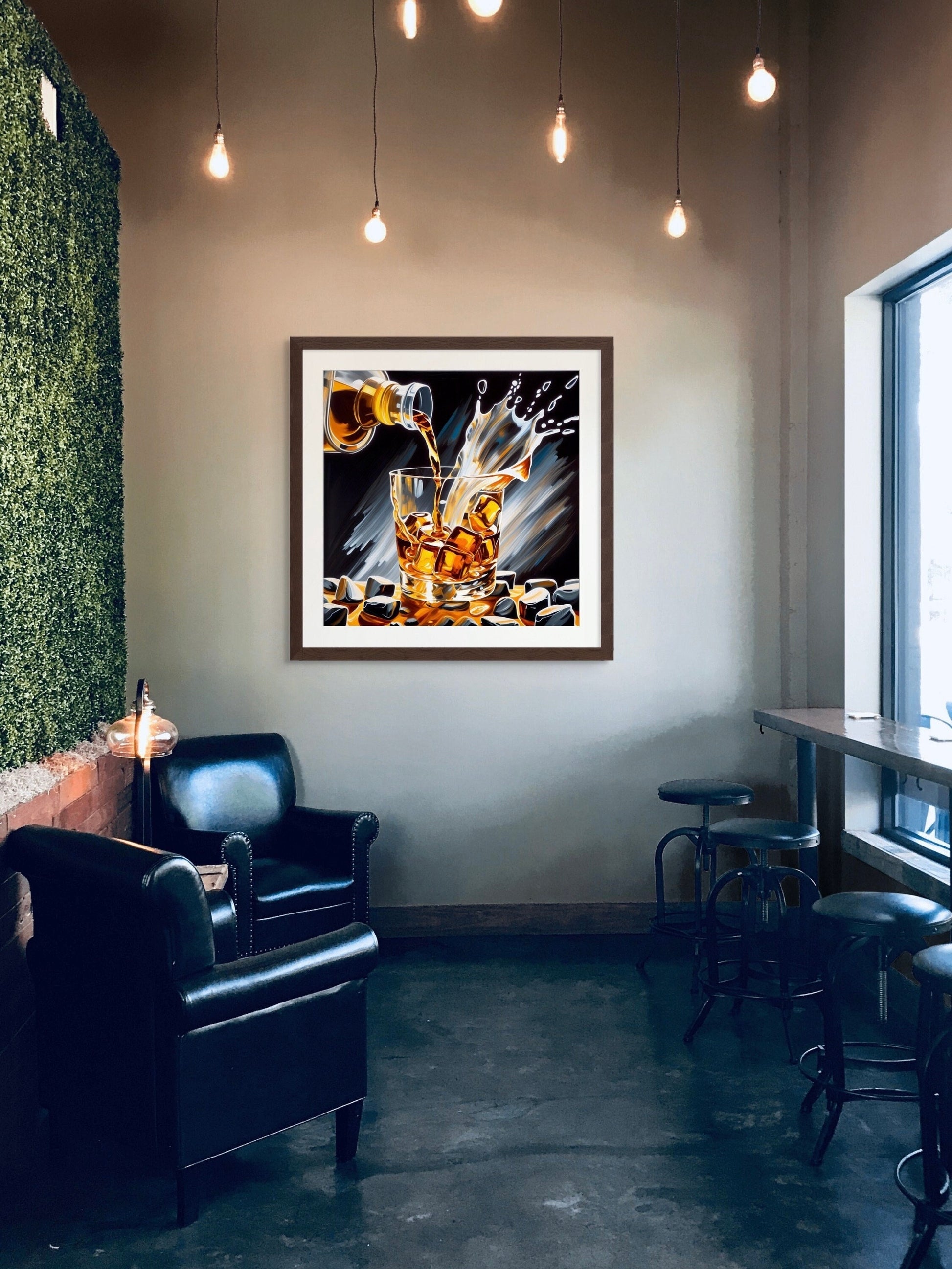 Whiskey on the Rocks Fine Art Giclee Print, with a white mat in a large 36&quot; x 36&quot; dark walnut picture frame, hanging on a wall in a cafe above a chair and stools with edison lights hanging down from ceiling.